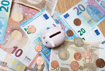 Piggy bank closeup, money and finance concepts. Photographed with Euro currency
