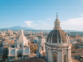 Aerial view of the Cathedral of Sant'Agata in the middle of Catania with Etna volcano on the...