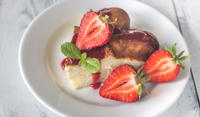 Slice of cheesecake with fresh strawberries