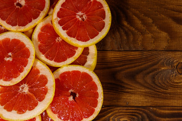 Sliced grapefruits on wooden table. Top view, copy space