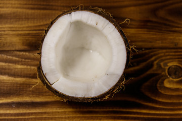 Fresh ripe coconut on rustic wooden table