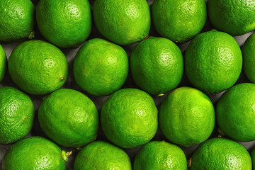 Fresh ripe green limes as background