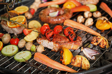 Barbecue grill with delicious cooked meat and vegetables, closeup