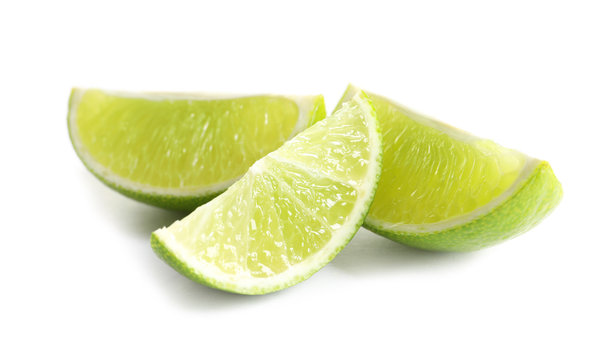 Slices of fresh ripe lime on white background