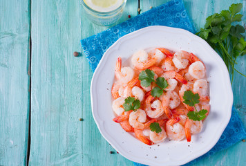 boiled shrimps on wooden surface
