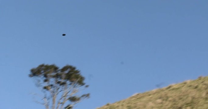 Clay target hit mid-air in the New Zealand hills