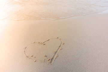 Beautiful background beach with draw shape heart on sand and wave on seaside beach in summer. Royalty high-quality free stock video footage of shape heart draw on the sand and waves on coastline beach