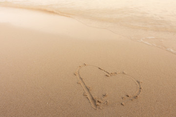 Beautiful background beach with heart in summer. Royalty high-quality free stock image of shape heart draw on the sand and beach