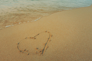 Beautiful background beach with draw shape heart on sand and wave on seaside beach in summer. Royalty high-quality free stock video footage of shape heart draw on the sand and waves on coastline beach