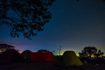 Night camping. Royalty high quality free stock image of night camp in forest under amazing night sky full of stars. Tent camping under starry night