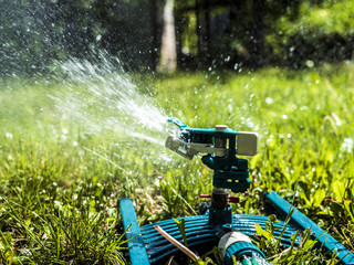close up garden lawn  irrigation system sprinkers splashes