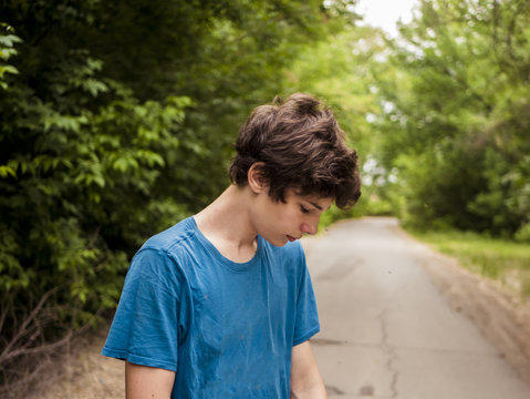 young hipster teenager walking on the alley