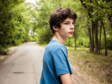 young hipster teenager walking on the alley