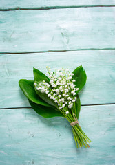 lilly of the valley flowers on wooden surface
