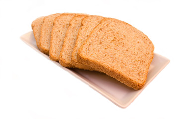 Slices of wholemeal bread on a white background close up view