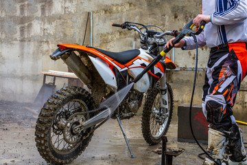 Fototapeta na wymiar biker washes a motorcycle