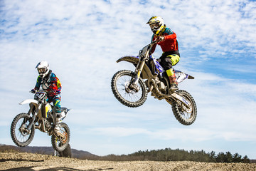 two extreme riders in a jump