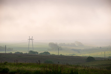 Fototapeta na wymiar Landscape in morning. Green hills in morning mist