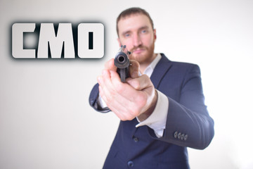 The businessman holds a gun in his hand and shows the inscription:CMO