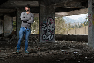 Strong Man in Grey Shirt Background Graffiti Wall