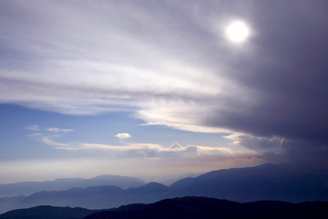 clouds in the sky against the bright sun in the highlands