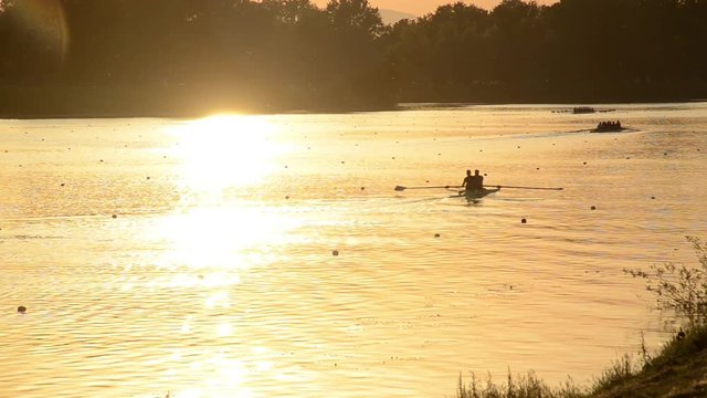Jarun lake near Zagreb, Croatia. Sport and recreation. Rowing, kayak and canoe. Rowing team training at sunset
