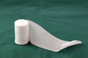 Sterile roll gauze on green operation cloth.