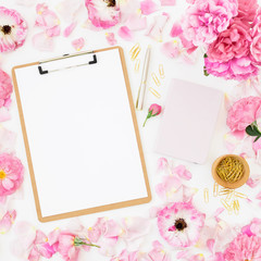 Beauty blog composition with dairy, pink roses, petals, pen and clipboard on white background. Top view. Flat lay.
