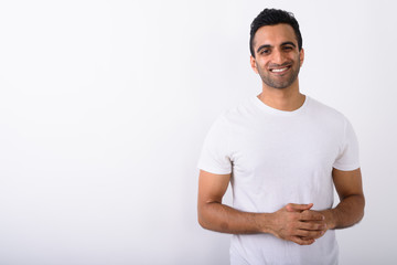 Young handsome Indian man against white background