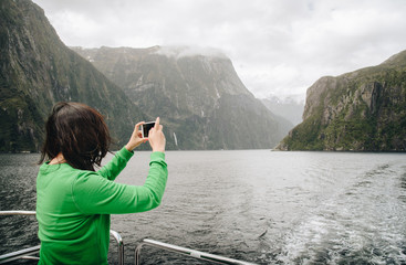 Fototapeta na wymiar Tourist travel in Milford Sound, New Zealand's most spectacular natural attraction in south island of New Zealand.