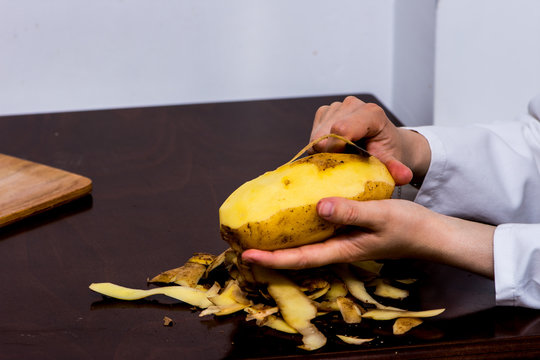 The woman peeling the potato