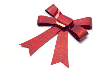 Red ribbon with bow isolated on a white background.