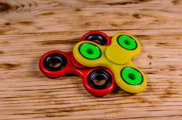Two fidget spinners on wooden desk