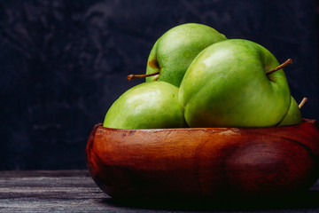 Beautiful apples in a wooden bowl