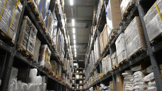 Warehouse or hangar storage racks or shelves with boxes and goods