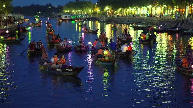Hoian, Vietnam - MAY 2018: Night river view with floating lanterns and boats. Hoi An, once known as Faifo. Hoian is a city in Vietnam and noted since 1999 as a UNESCO World Heritage Site