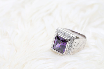 purple gemstone on diamond ring