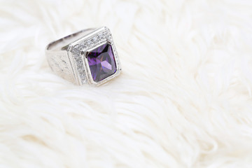purple gemstone on diamond ring