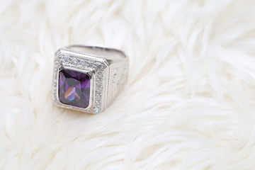 purple gemstone on diamond ring