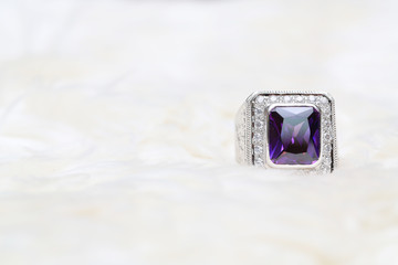 purple gemstone on diamond ring