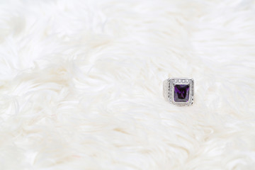 purple gemstone on diamond ring