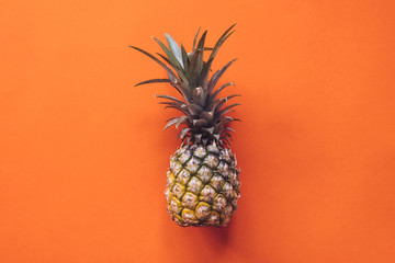 Top view of a pineapple on a orange background