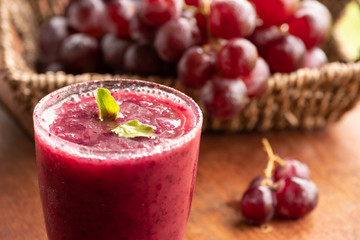 Glass of Grape juice smoothie on wooden table