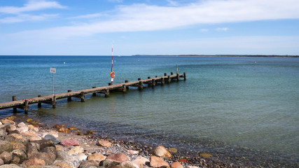 Fototapeta na wymiar Boat landing stage with rescue ring and rescue pole