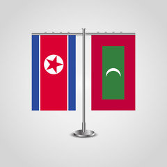 Table stand with flags of North Korea and Maldives.Two flag. Flag pole. Symbolizing the cooperation between the two countries. Table flags