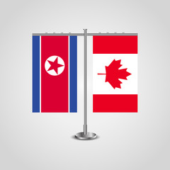 Table stand with flags of North Korea and Canada.Two flag. Flag pole. Symbolizing the cooperation between the two countries. Table flags