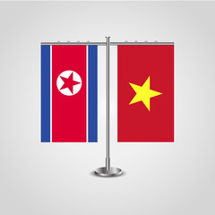Table stand with flags of North Korea and Vietnam.Two flag. Flag pole. Symbolizing the cooperation between the two countries. Table flags