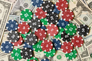 Poker chips on a pile of dollars . Winning concept