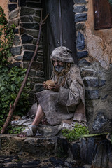 Fototapeta na wymiar Man, dressed in rags, begging through the streets of a village