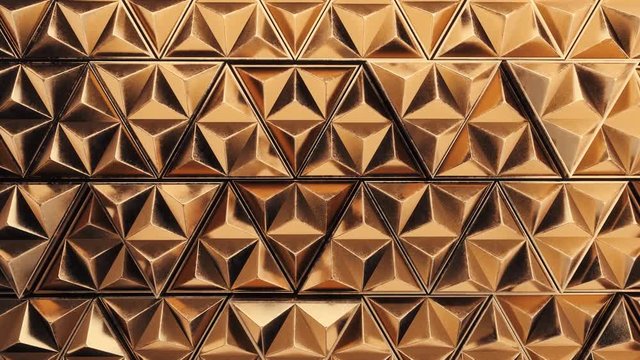 The golden wall surface made of triangular elements that moves back and forth irregularly. Abstract geometric background. Seamless looping animation, 3D render.